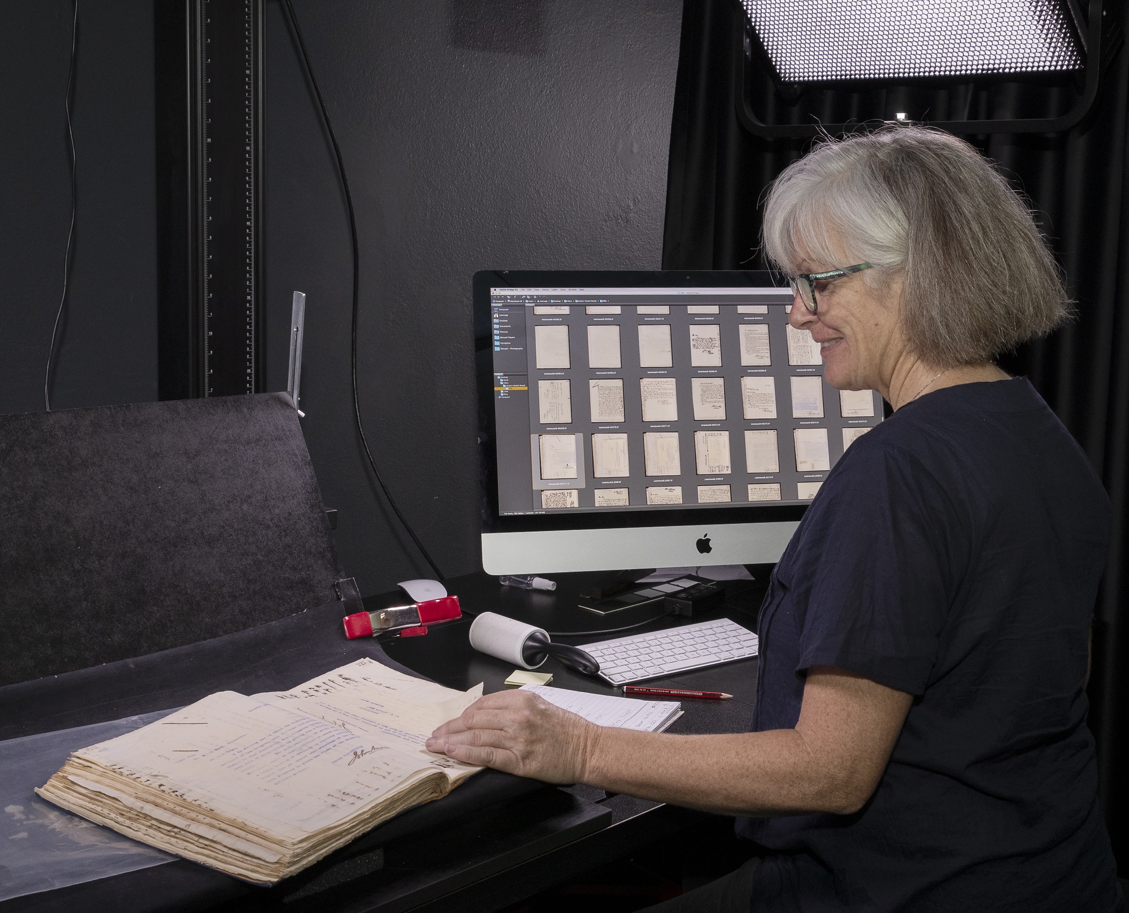 photographer reviewing digitised images of handwritten material