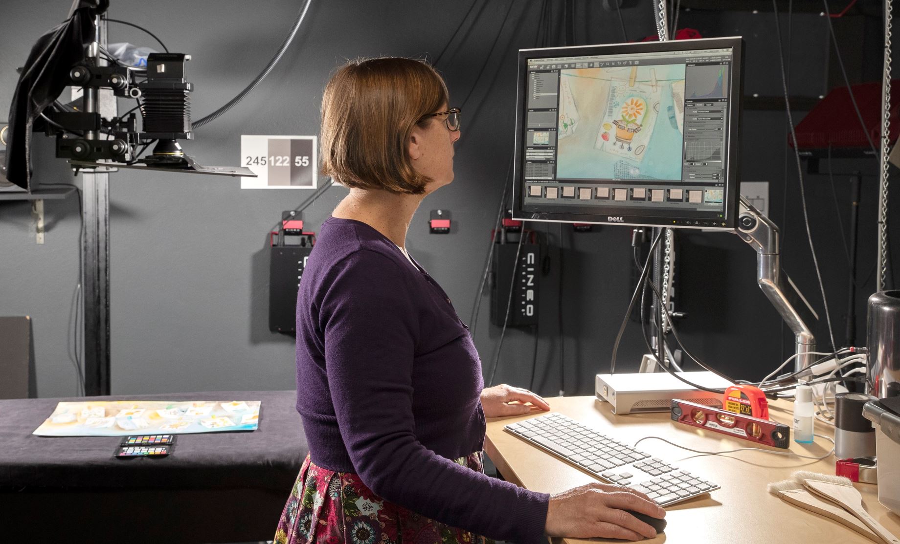 A staff member at the National Library of Australia digitises a map and looks at the image of it on a screen