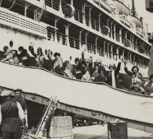 British migrants boarding ship and waving