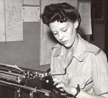 A women in a military uniform typing on a stenography machine