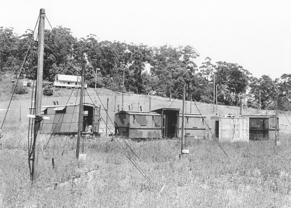 Huts and radio wires set up in a field