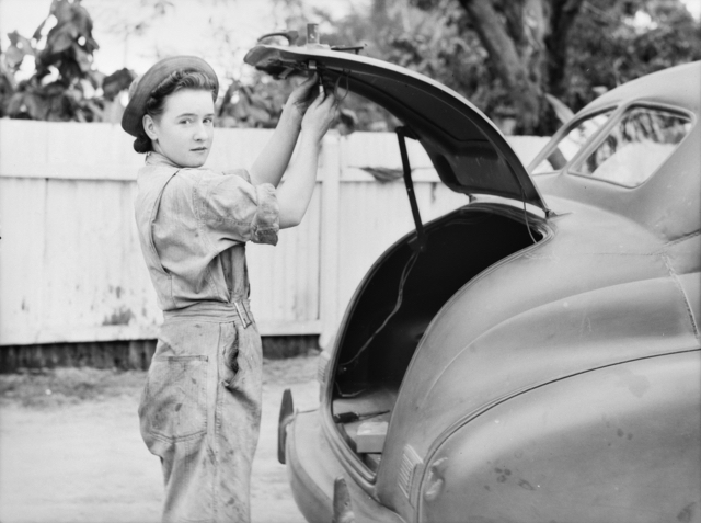 A women repairing a lock on the boot of a vehicle