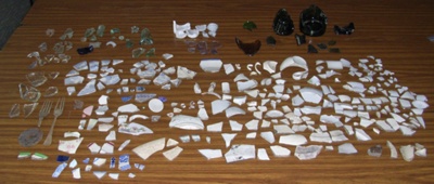 A collection of artifacts including metal, glass, ceramics and bone