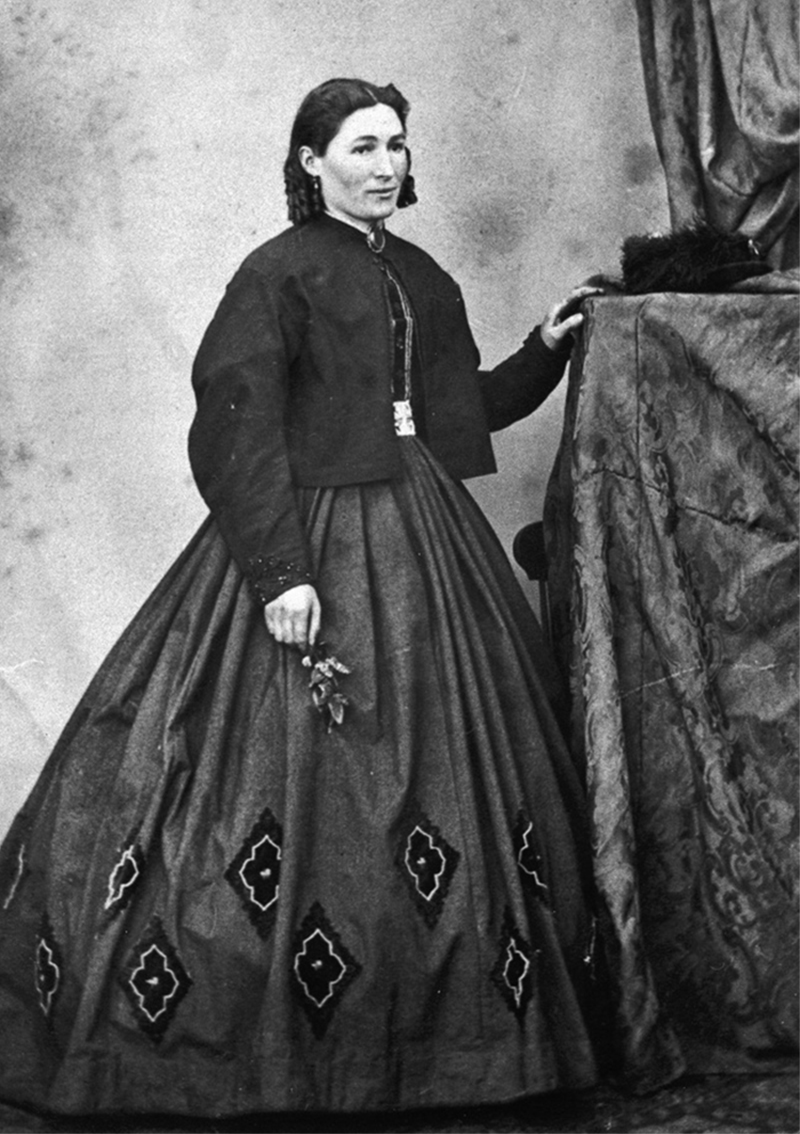 A young woman wearing a crinoline dress and black jacket