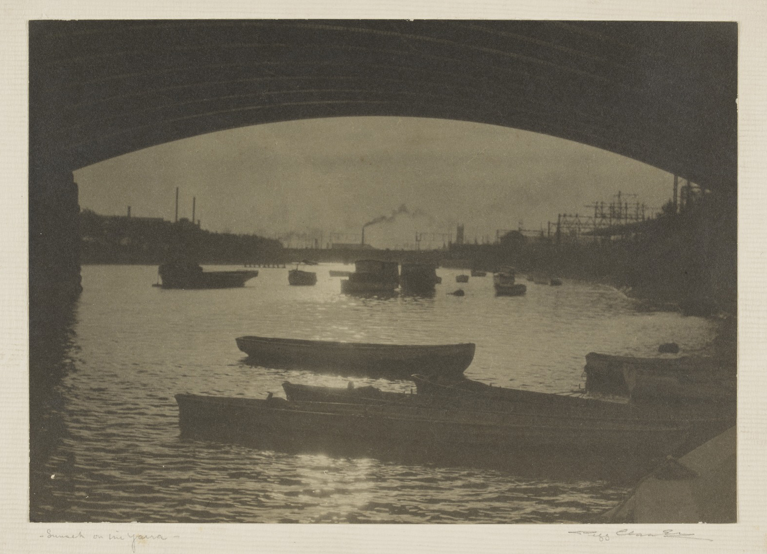 Landscape photo of the Yarra River at sunset. A bridge and boats are silhouetted