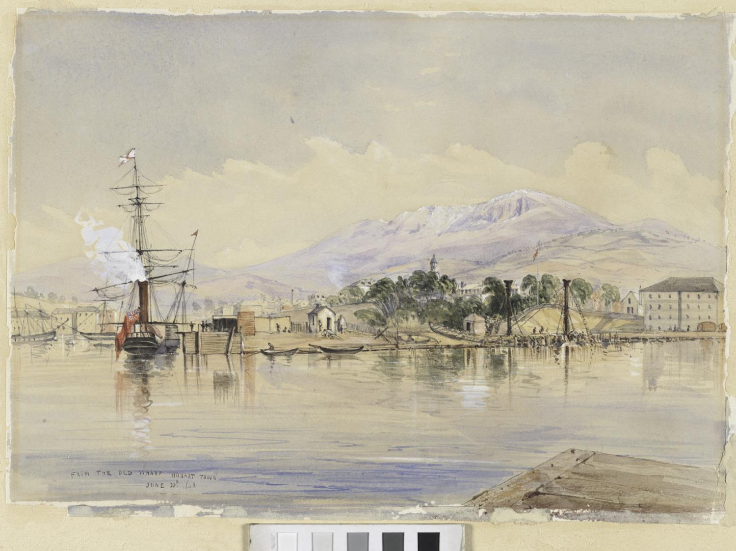 A tall, masted steamship chugs out white smoke in middle left. To its right are two boats, small wooden huts along the promontory. Further to the right is a low hill covered in bushes and below it are many people clustered together, a large boat, rigging and even further right is a tall, three-storey warehouse.