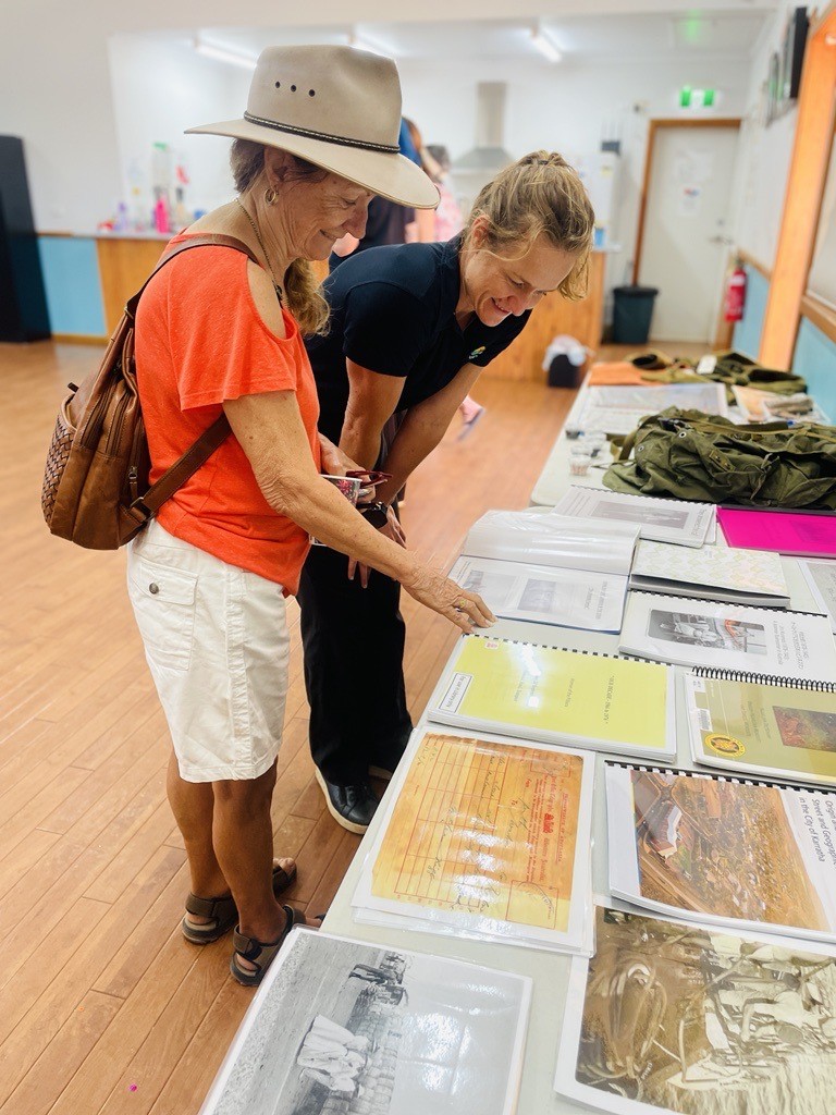 Two people looking at historical items on a table