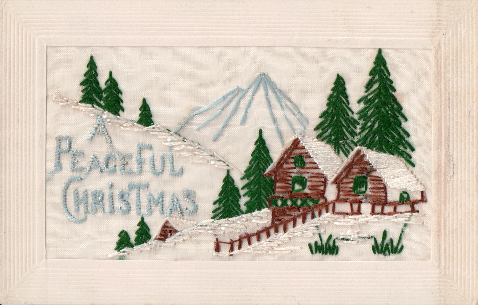 A postcard with 'A peaceful Christmas' on the front.
