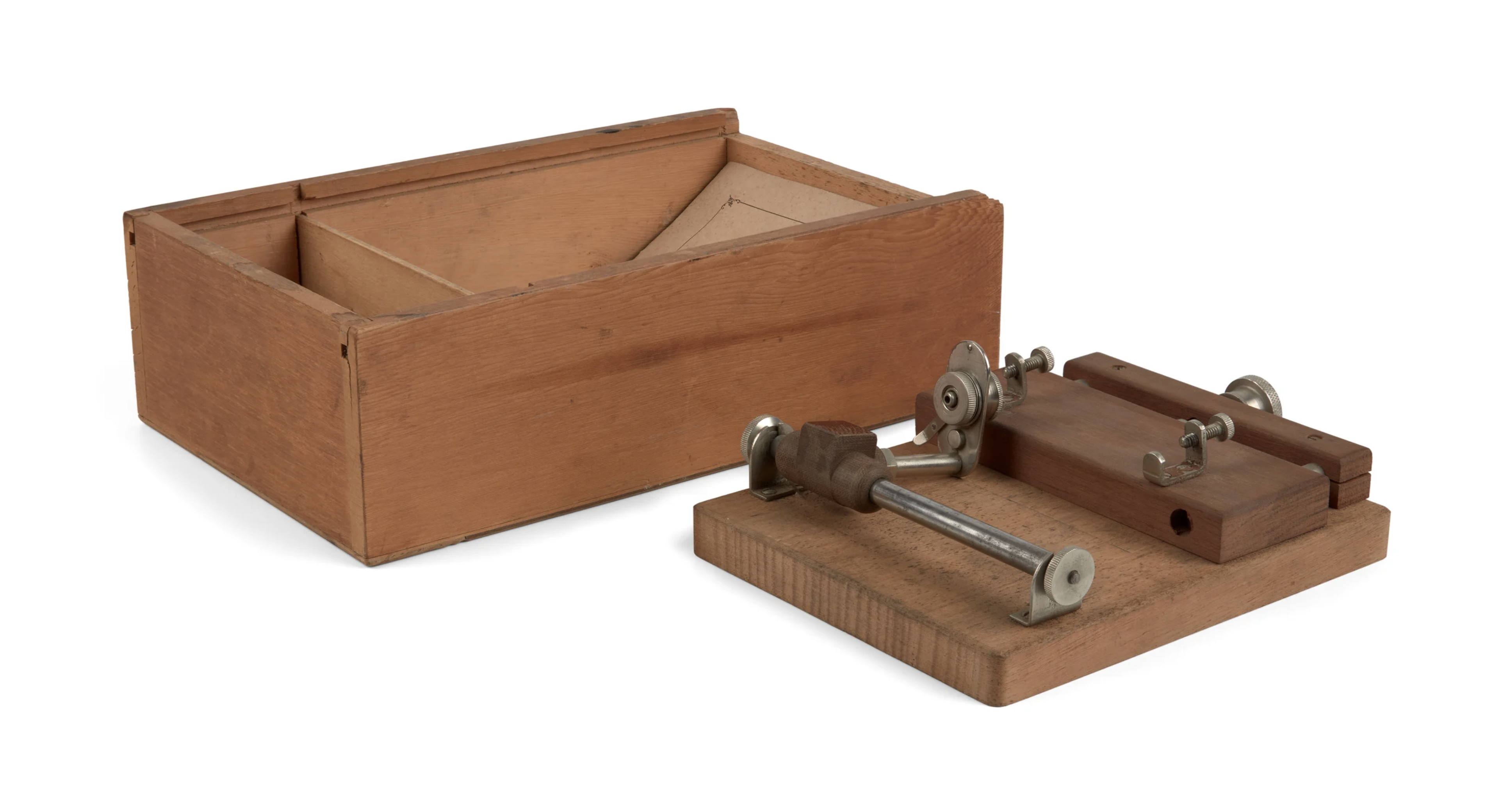 A needle sharpener next to a wooden box.