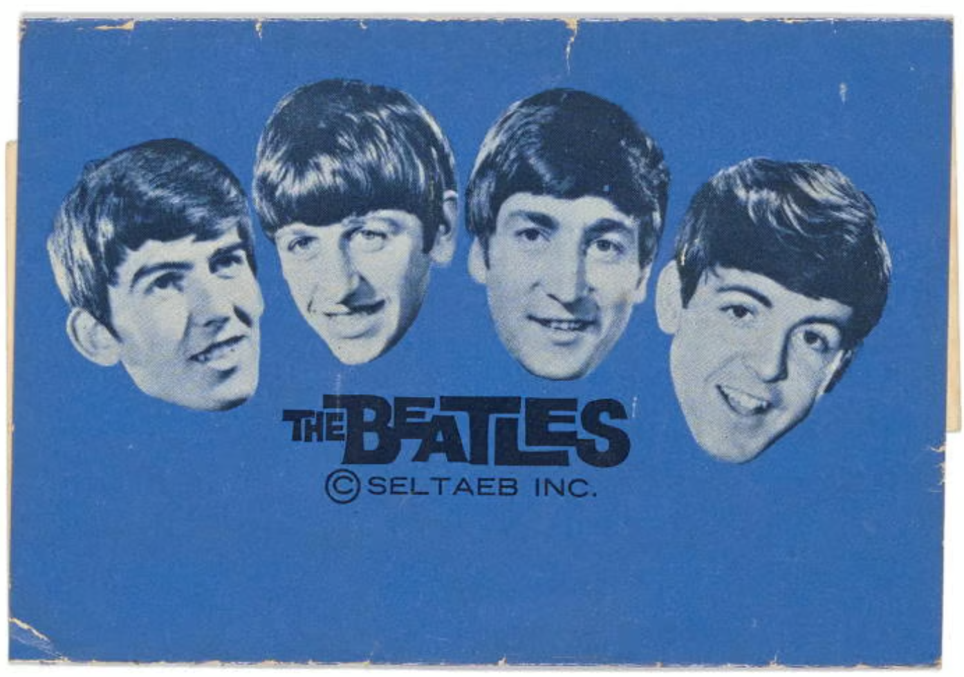 A blue background with the Beatles heads above the words 'The Beatles © Seltaeb Inc.'.