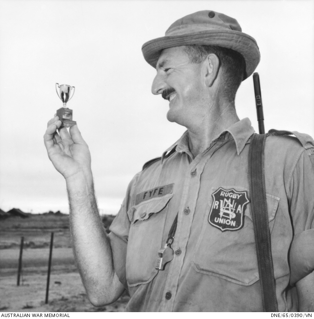 Man holding a small trophy