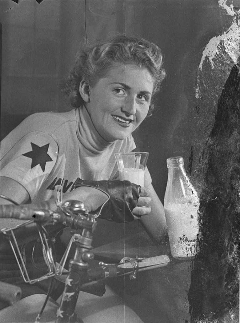 Joyce Barry in cycling gear drinking a glass of milk.