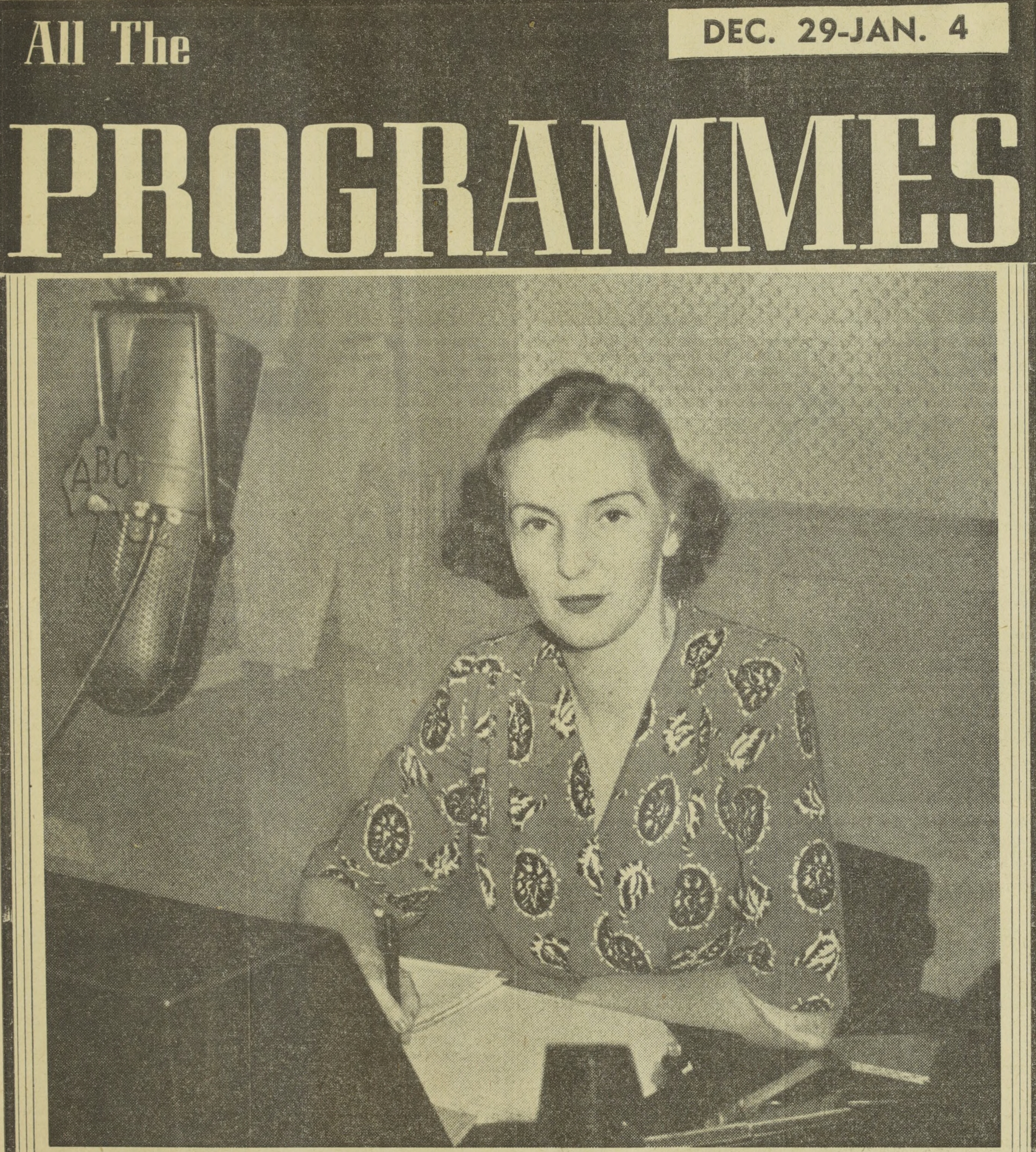 A photograph from a newspaper of Margaret sitting at a desk with a radio microphone in front of her. 