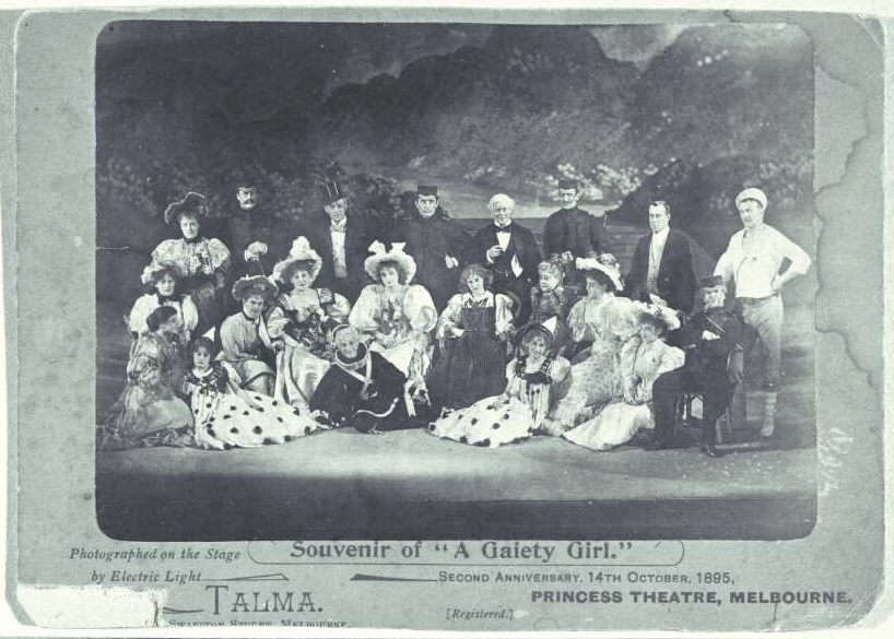 Group portrait of cast members for "A Gaiety Girl" posed on a stage