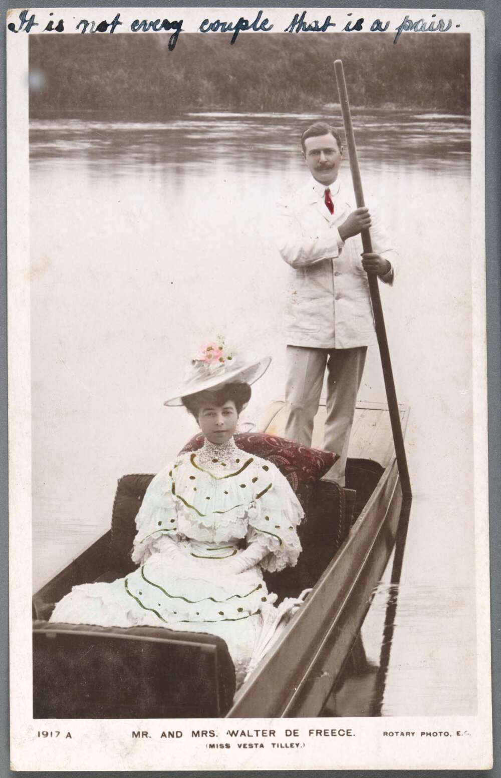 A picture of Walter and Vesta in a boat on the water. Walter is standing holding an oar and steering the boat. Vesta is sitting.