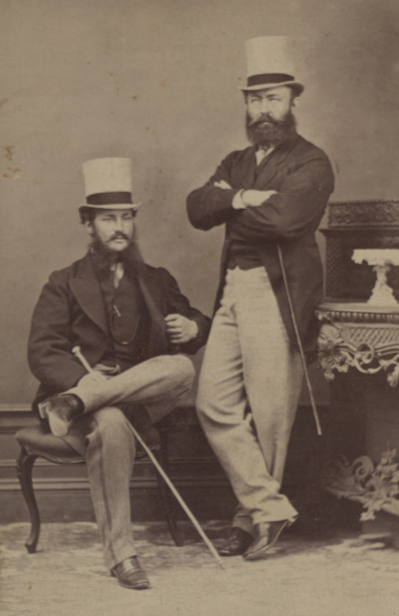 Two men wearing suits and top hats