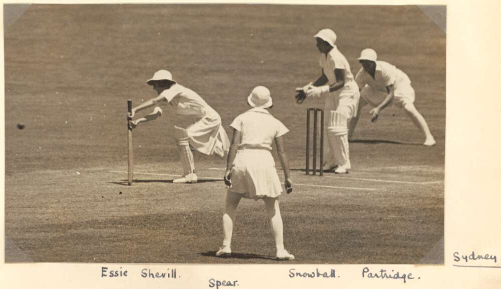 Four women playing cricket