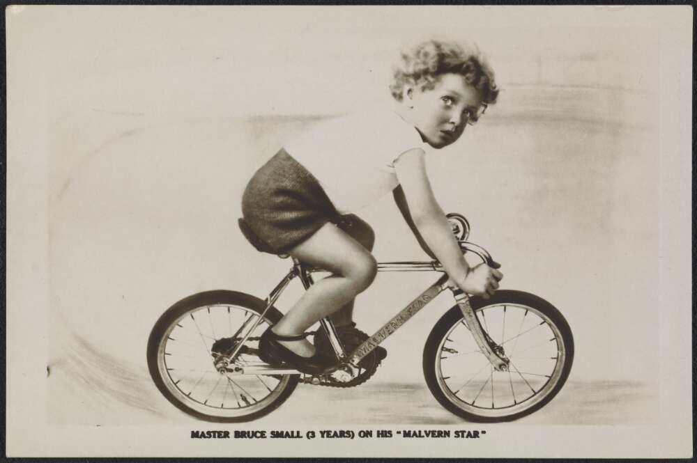 Bruce as a young child riding a bike.