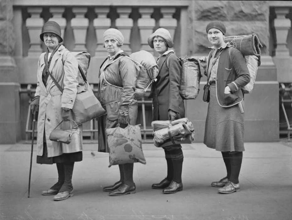 The group of four women posing for a photo with their backpacks on. 