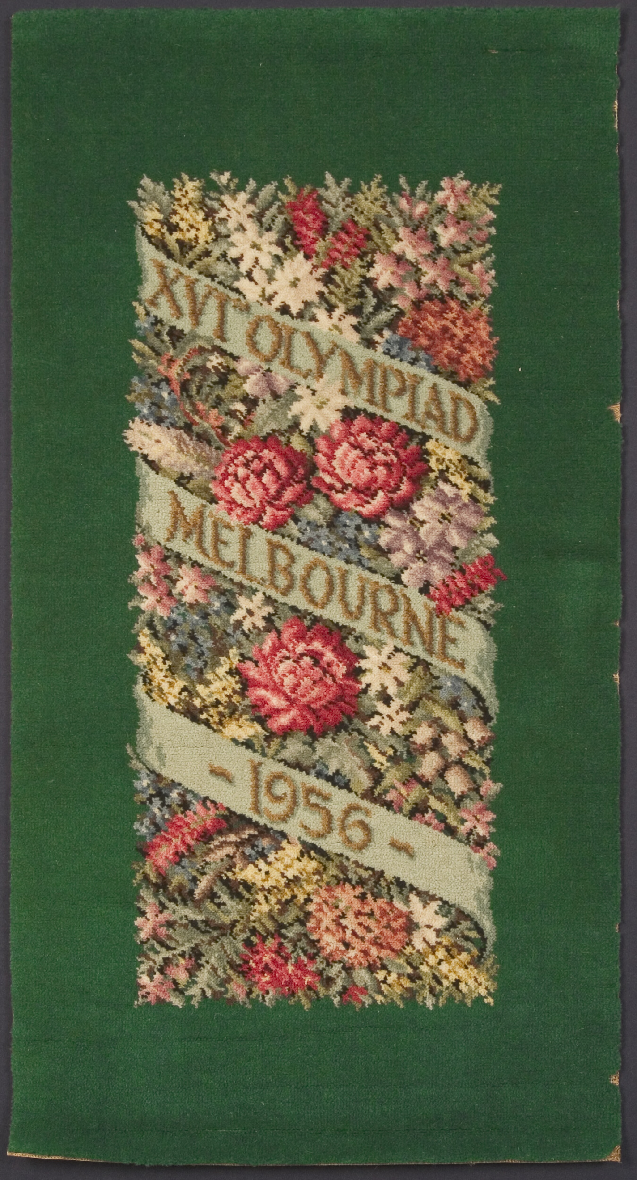 A colourful rug commemorating the 1956 Melbourne Olympic Games. It features Australian native flowers.
