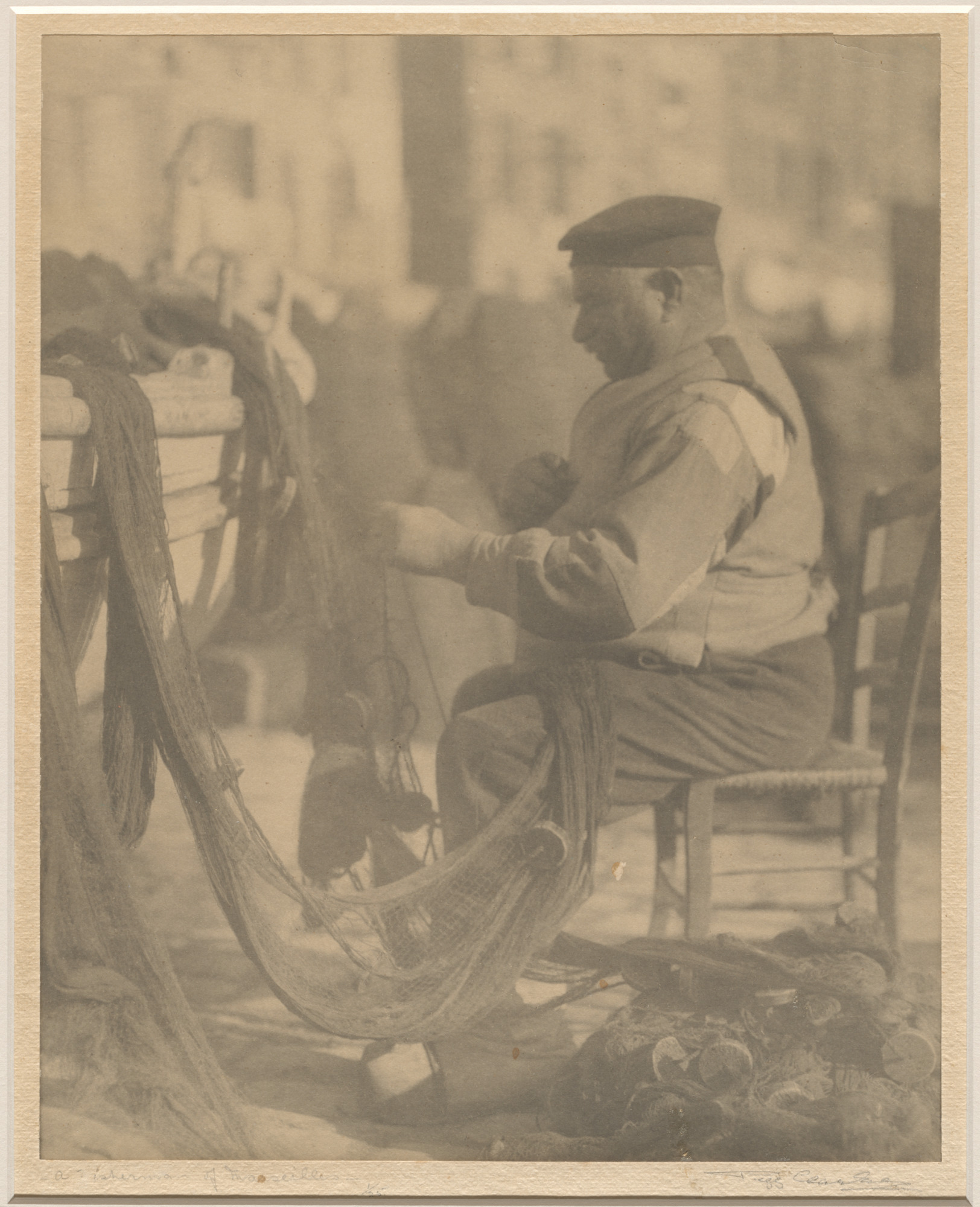 fisherman sitting in a chair and working with a net