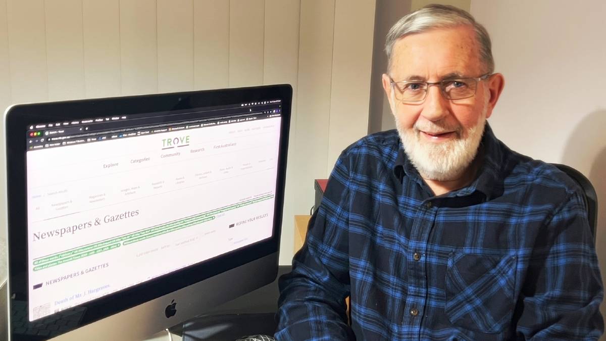 John Warren sitting at computer with Trove website