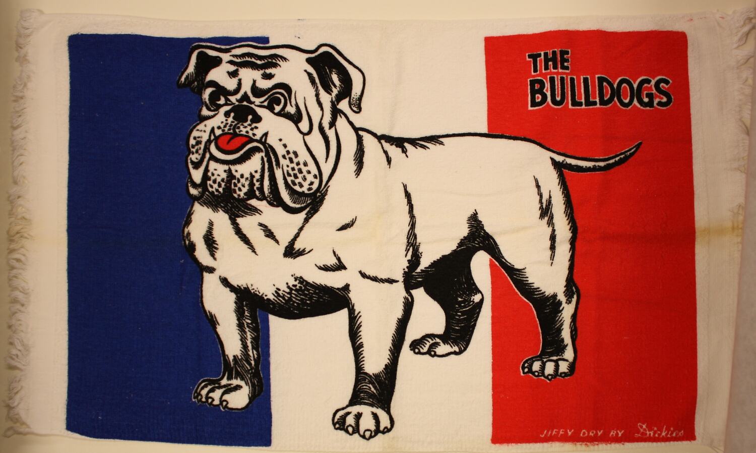 A tea towel with a bulldog on it along with the words "The Bulldogs"