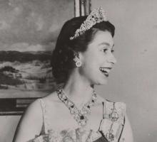 Queen Elizabeth II smiling and dressed in regalia