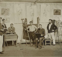 Seven men in a painting studio. 